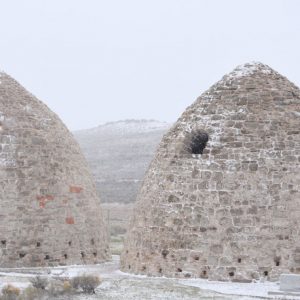 Two beehive-shaped kilns, each one is 30 feet across and 30 feet high and are dusted with snow