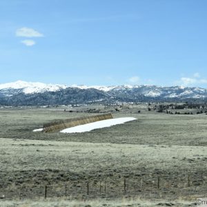 The range in the foreground followed by a backdrop of snow-capped mountians